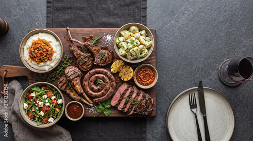 African dish: bbq meat platter on a table seen from above with copy space, ad image traditional African food