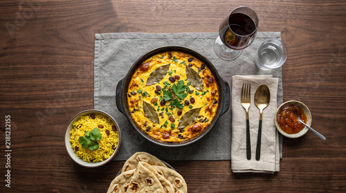 African stew dish: Bobotie dish, on a table seen from above with copy space, ad image traditional African food