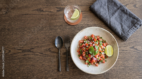 African dish: Kachumbari salad on a table seen from above with copy space, ad image traditional African food