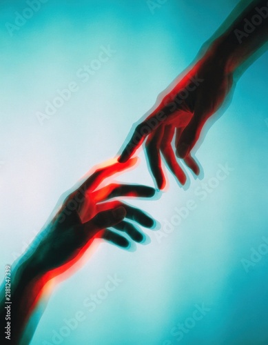 Two human hands reaching towards each other with red and blue light effects