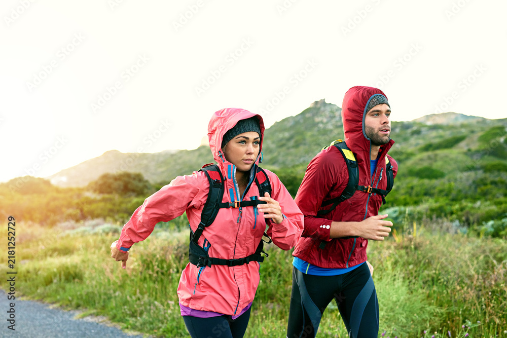 Fototapeta premium Fitness, couple and running in countryside for health, training or practice together for wellness. Man, woman and runner jog in nature, workout and cardio conditioning with exercise partner in winter