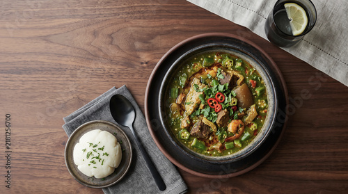 African stew dish: okra dish, on a table seen from above with copy space, ad image traditional African food