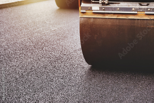 Canvas Print Laying Asphalt Concrete on a Busy City Street During Daytime Roadworks Process
