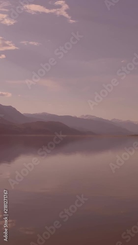 View of landscape with lake, mountains and clouds in the blue sky