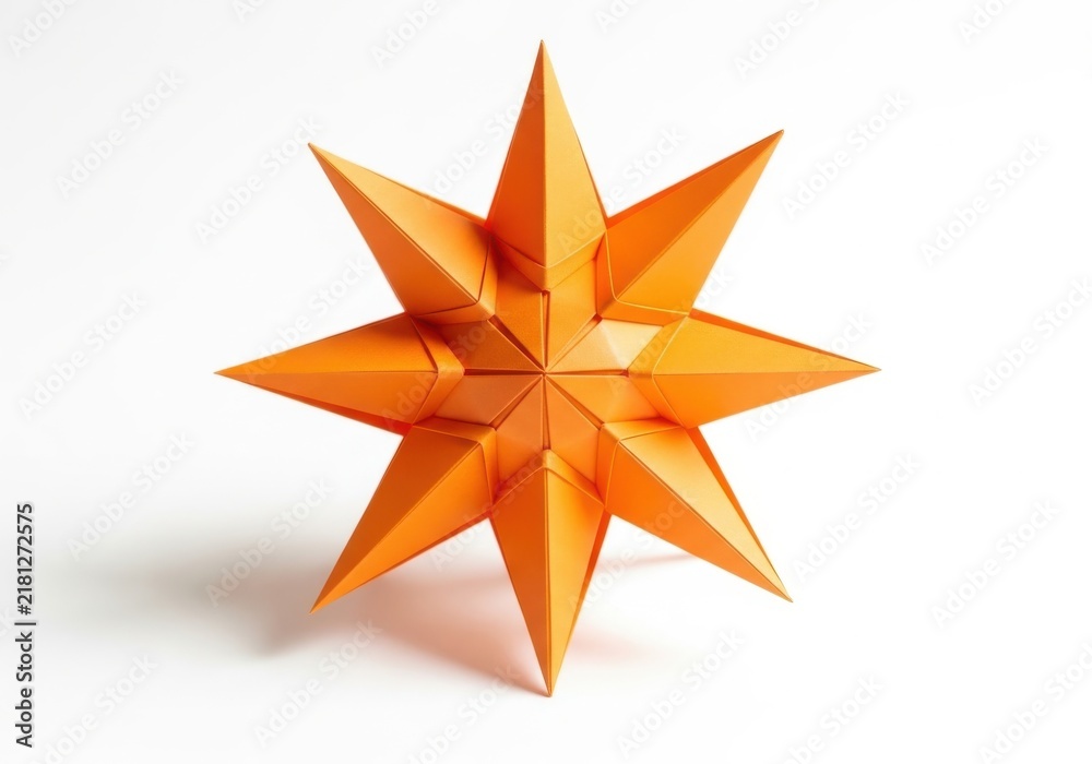 Fototapeta premium Vibrant orange origami star with sharp geometric points isolated on white.