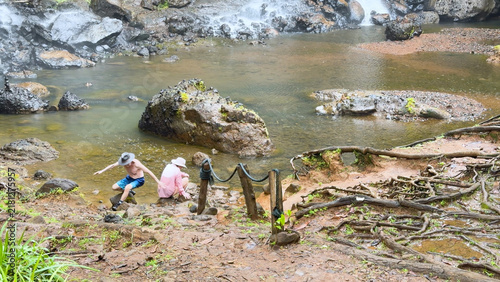 Obraz na plátně Tourist Slipping on Muddy Ground Near Ngardmau Waterfall in Palau