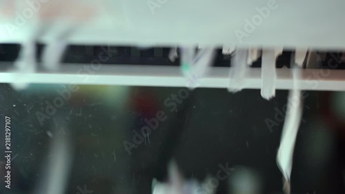 Close Up Macro View of Shredded Paper Strips Coming Out of Electric Paper Shredder Machine