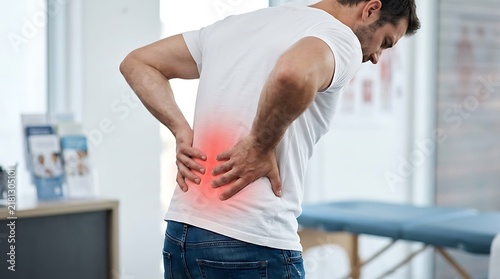 Man holding lower back in pain for world arthritis day awareness