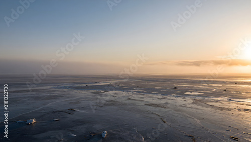 Expansive frozen landscape at sunrise or sunset