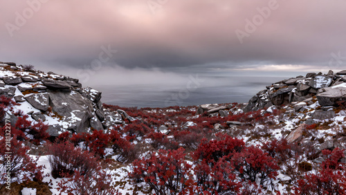 Mountain landscape under dramatic cloudy sky overlooking the sea