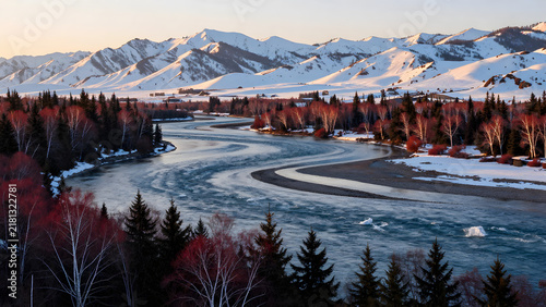 Winding river through snowy mountains and forest landscape