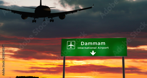 Plane landing in Dammam Saudi Arabia airport with signboard