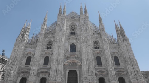 Upward video revealing the ornate facade of Milan Cathedral from the entrance to its Gothic spires, showcasing the intricate architecture of this iconic landmark in Italy.