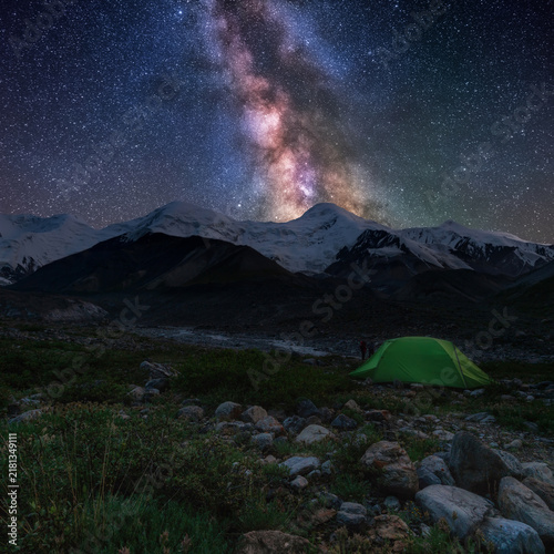 Milky Way over Bayankol Valley with camping scene in Central Tien Shan mountains