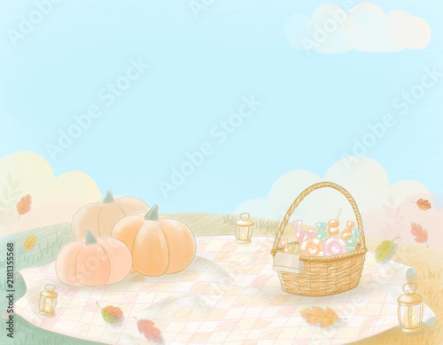 かぼちゃとお菓子のバスケットを飾ったかわいい秋のハロウィンピクニック背景