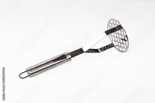 Photography Stainless steel potato masher with black grip on white background