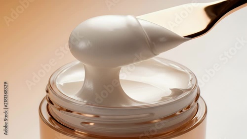 Luxurious White Cream Texture Being Scooped From Glass Jar With Metallic Spatula in Professional Skincare Cosmetic Context 4K