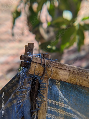 Фотография Close up macro view of a rustic bamboo frame joint tied tightly with blue plasti