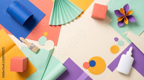 Colorful paper craft supplies arranged on a flat lay background
