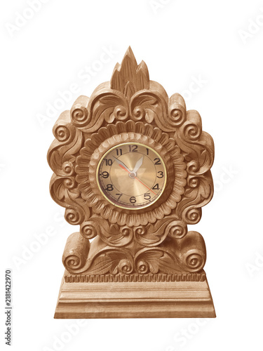 Antique analog clock with decorative wooden carvings isolated on white background.