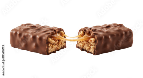Chocolate candy bar broken in half with gooey caramel and peanuts stretching between pieces on transparent background.