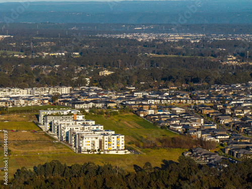 Aerial view of modern apartment developments and residential housing in the urban fringe of Schofields, New South Wales, Australia.