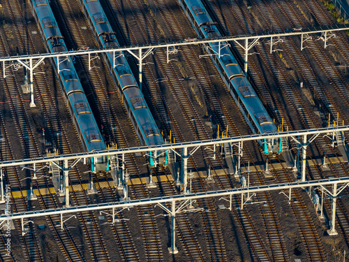Aerial view of stabled metro trains parked on parallel tracks at an electric train depot with overhead railway gantries in Tallawong, New South Wales, Australia.