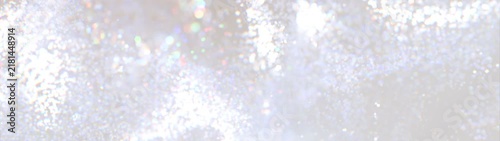 Soft abstract bokeh with rainbow highlights, creating an atmosphere of dreaminess and lightness. 
Abstract white background with bokeh effect. Glitter lights background. 