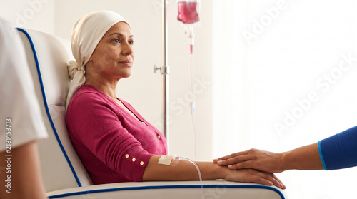 Woman undergoing chemotherapy treatment while receiving IV infusion  