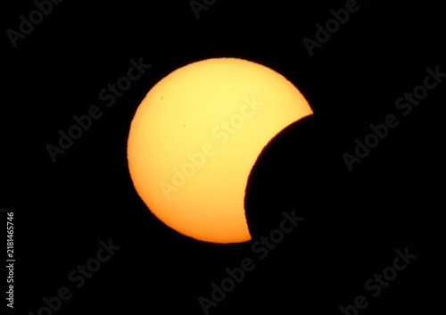 Принти на полотні Crisp telephoto close-up of a partial solar eclipse against a pure black sky, featuring visible sunspots and a clear, detailed solar disk