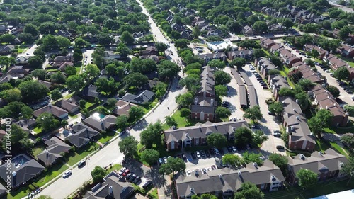 Residential neighborhoods converge around Parkway Boulevard near Saint Ann Catholic Parish. Clustered apartment complexes, private backyard pools, curving suburban roadways frame Coppell, Texas.