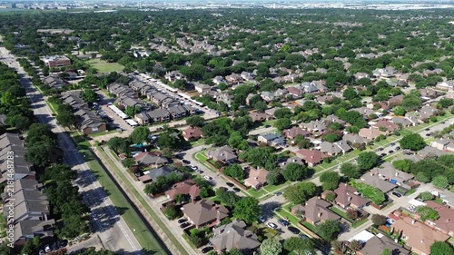 Suburban residential neighborhoods surround Parkway Boulevard near Town Center Elementary School. Brick single family residences, curving cul-de-sacs, dense green foliage fill Coppell, Texas.