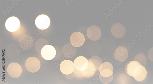 Warm luminous circles shine through soft focus creating golden bokeh with a serene dreamy atmosphere