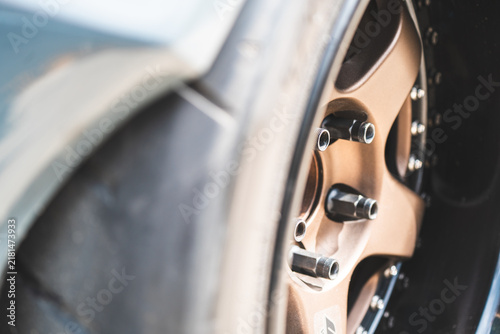 Close-up of a large exclusive alloy wheel and low-profile tire on a sports car
