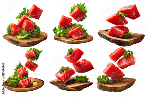 Slices of raw tuna sashimi with green shiso leaves and parsley garnish isolated on white background, Japanese cuisine freshness