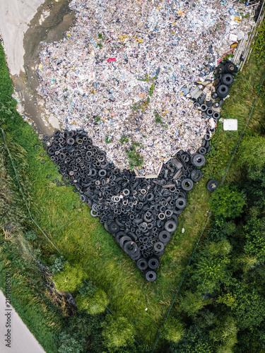 Aerial view of a landfill site with a massive pile of discarded tires and mixed consumer waste, highlighting environmental challenges in Laidzes pagasts, Talsu novads, Latvia.