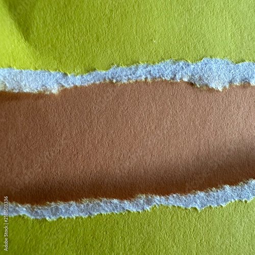 Torn lime green paper revealing a brown cardstock layer beneath