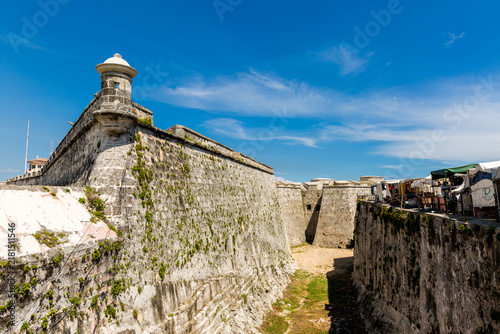 Ancient Stone Fortress Wall with Watchtower and Moat