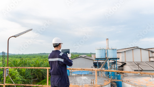 Environmental engineering using digital tablet taking photo environment report for clean air of air pollution reduction industrial plants. Engineer analysis sustainable energy saving. ESG. CEMS