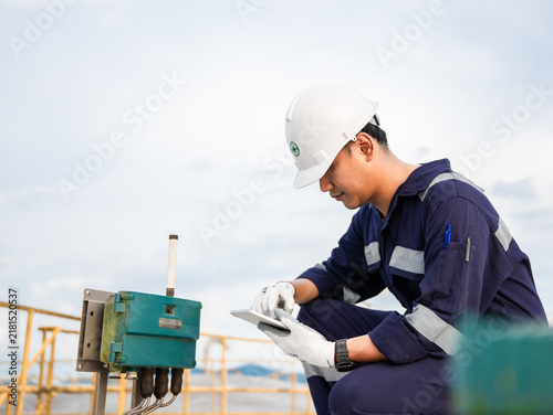 Petrochemical engineering checking controllers crude oil storage tank factory and industry. Maintenance engineer analysis work manufacturing production palm oil at refinery industrial plant. Fuel gas