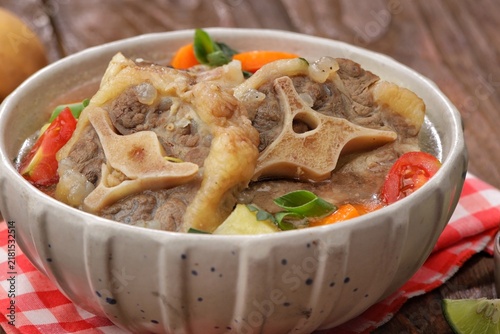 Obraz na plátně Sop buntut or oxtail soup, a traditional Indonesian oxtail soup made with tender beef oxtail simmered in a rich and flavorful broth with vegetables and aromatic spices