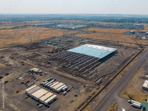 Umatilla, United States - 15 August 2026: Aerial view of Umatilla Sabey Data Center construction site with steel framework, heavy machinery, and temporary office trailers.