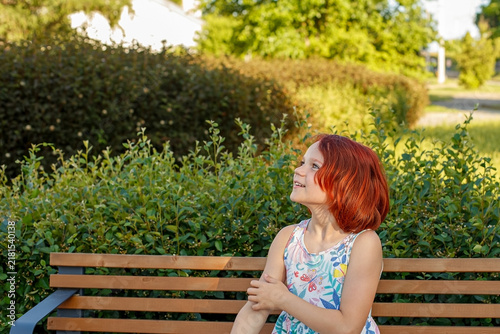 A portrait of a smiling teenage girl enjoying a sunny summer day.