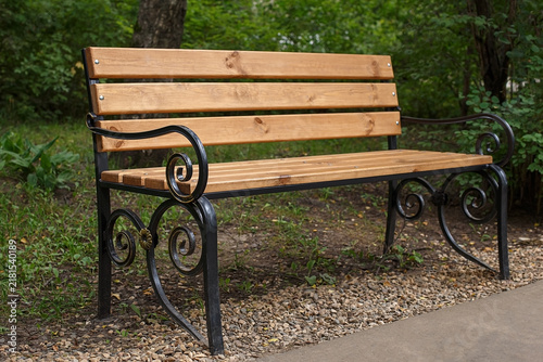 A wooden bench in a city park.