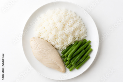 Flavorless bland diet meal, plain white plate with steamed rice, boiled chicken breast and unsalted green beans
