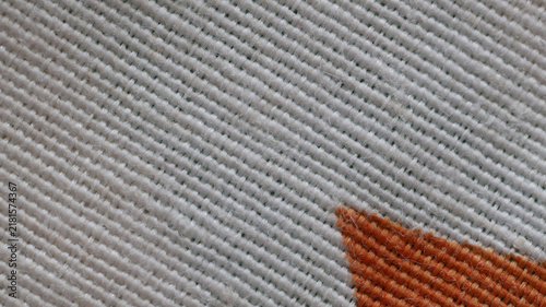 White textile texture close up with orange corner