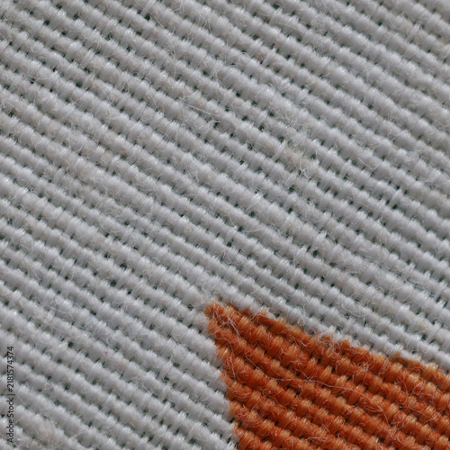 White textile texture close up with orange corner 