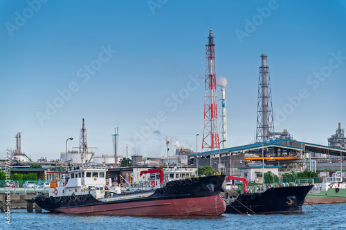 Photography Oil tanker and equipment of gas oil refining plant in Japan industrial factory area with blue sky background view from Fishing port, Yokkaichi, Mie Prefecture, Japan
