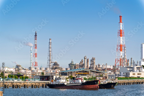 Photography Oil tanker and equipment of gas oil refining plant in Japan industrial factory area with blue sky background view from Fishing port, Yokkaichi, Mie Prefecture, Japan