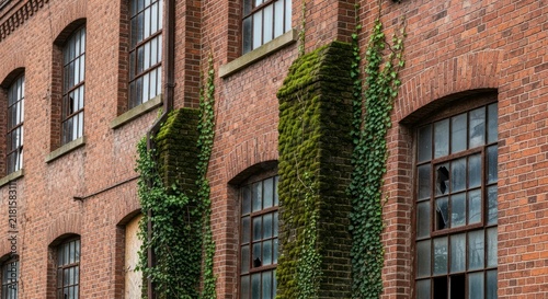 Brick building with ivy covered columns.